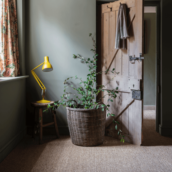 fancy lamp on stool behind door