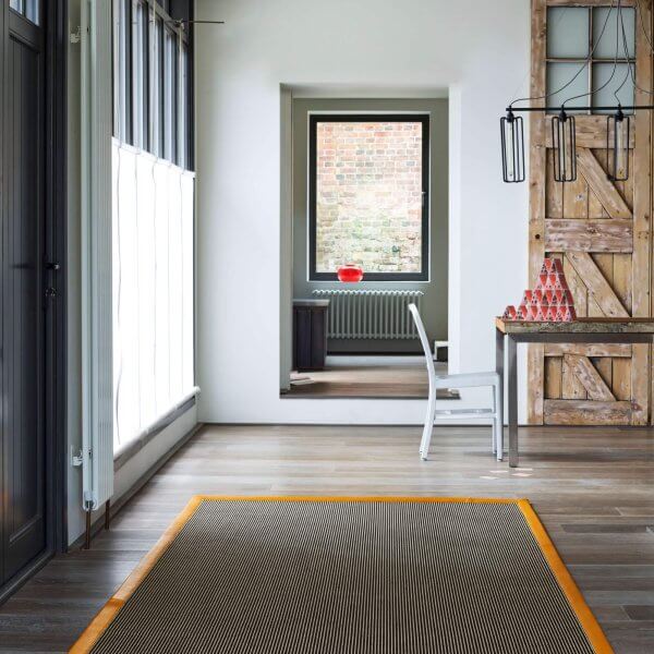 black linen and wool rug yellow border